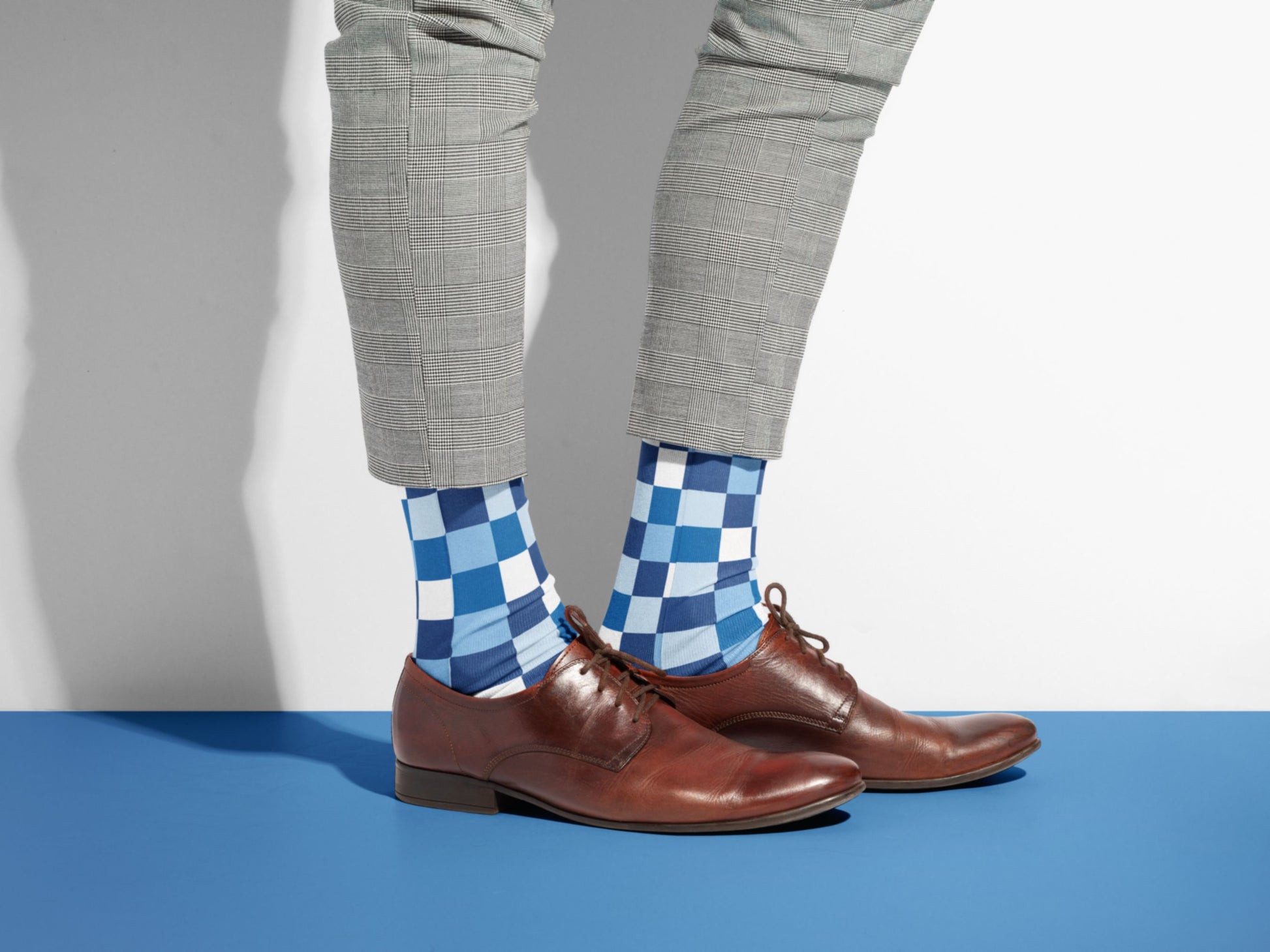 Blue Checkerboard Socks styled with dress shoes in a lifestyle shot