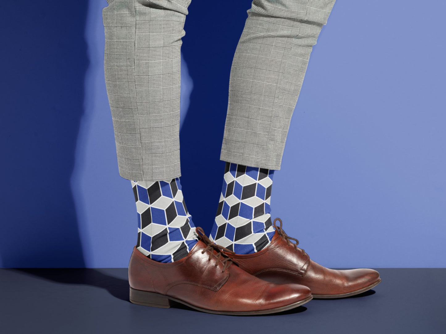 Navy Geometric Dress Socks styled with dress shoes in a lifestyle shot