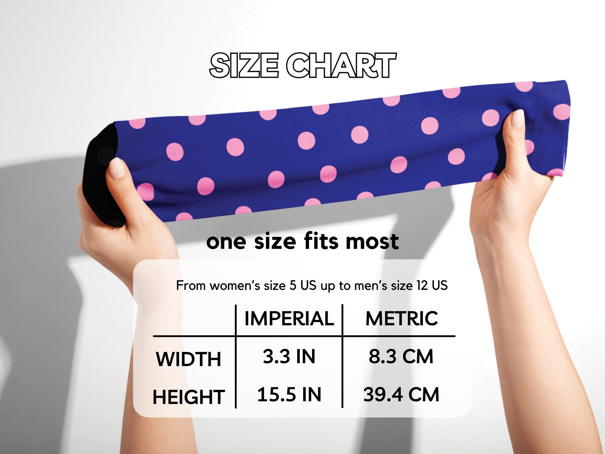 Hands stretching navy polka dot socks with size chart overlay
