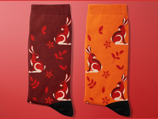 Rabbit Zodiac Socks - Lunar New Year Gift - Astrology Inspired Socks - flat-lay on red background