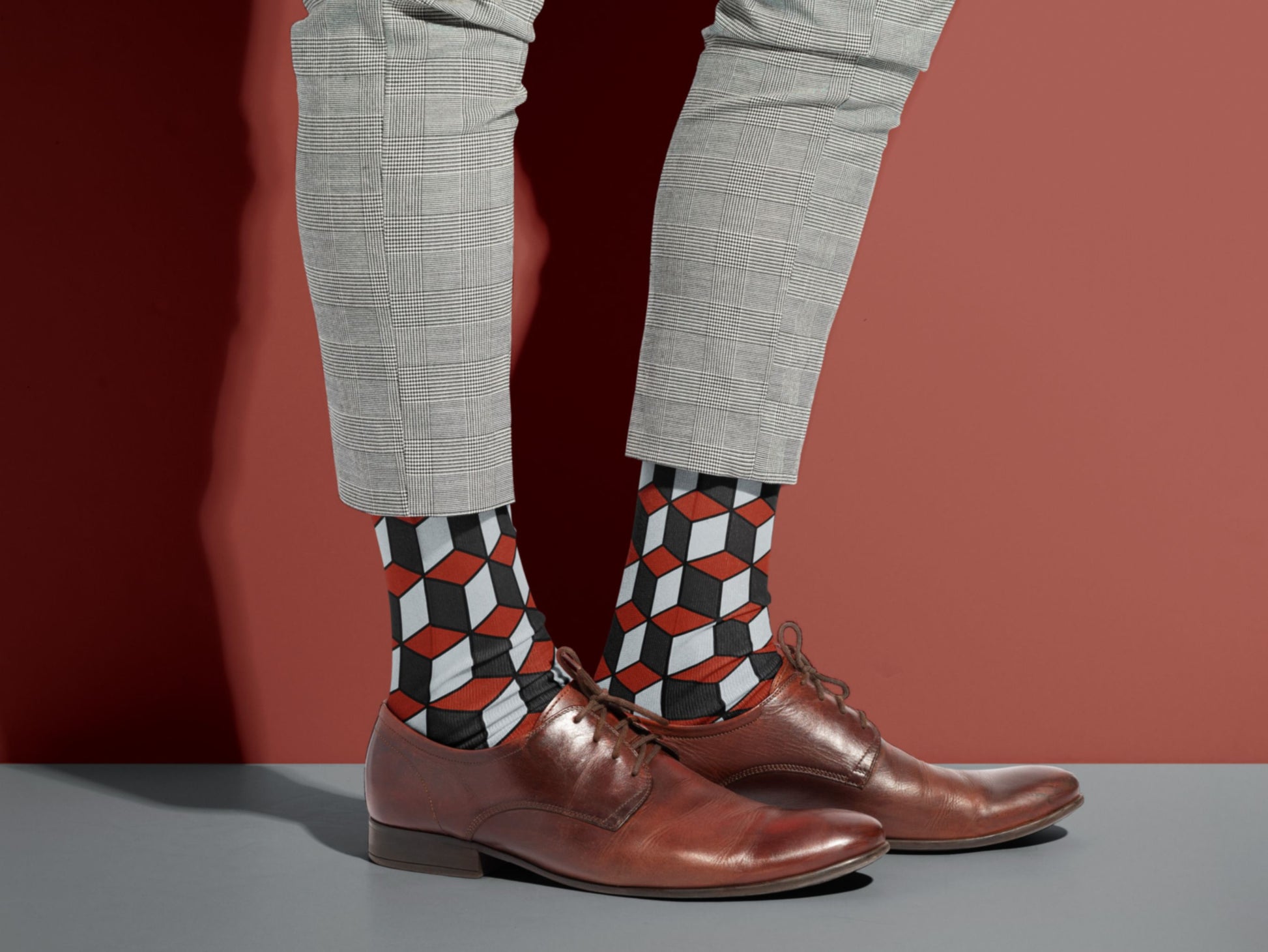 Red & Black 3D Cube Dress Socks styled with dress shoes in a lifestyle shot