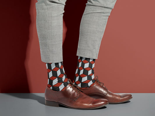 Red & Black 3D Cube Dress Socks styled with dress shoes in a lifestyle shot