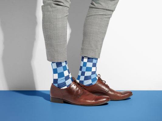 Blue Checkerboard Socks styled with dress shoes in a lifestyle shot