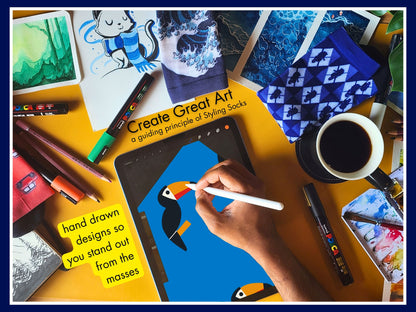 Bright Blue Toucan Bird Socks – Colourful Crew artist hand drawing the sock design on a tablet