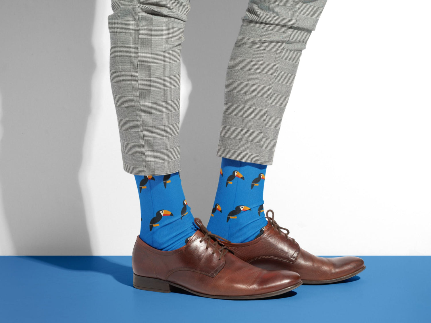Bright Blue Toucan Bird Socks – Colourful Crew styled with dress shoes in a lifestyle shot