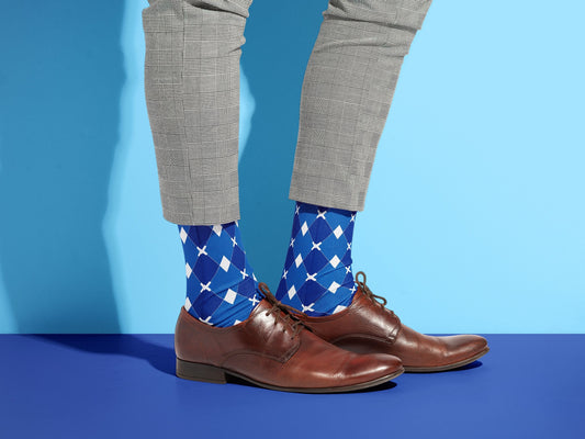 Blue & White Argyle Dress Socks styled with dress shoes in a lifestyle shot