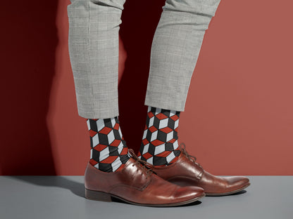 Red & Black 3D Cube Dress Socks styled with dress shoes in a lifestyle shot